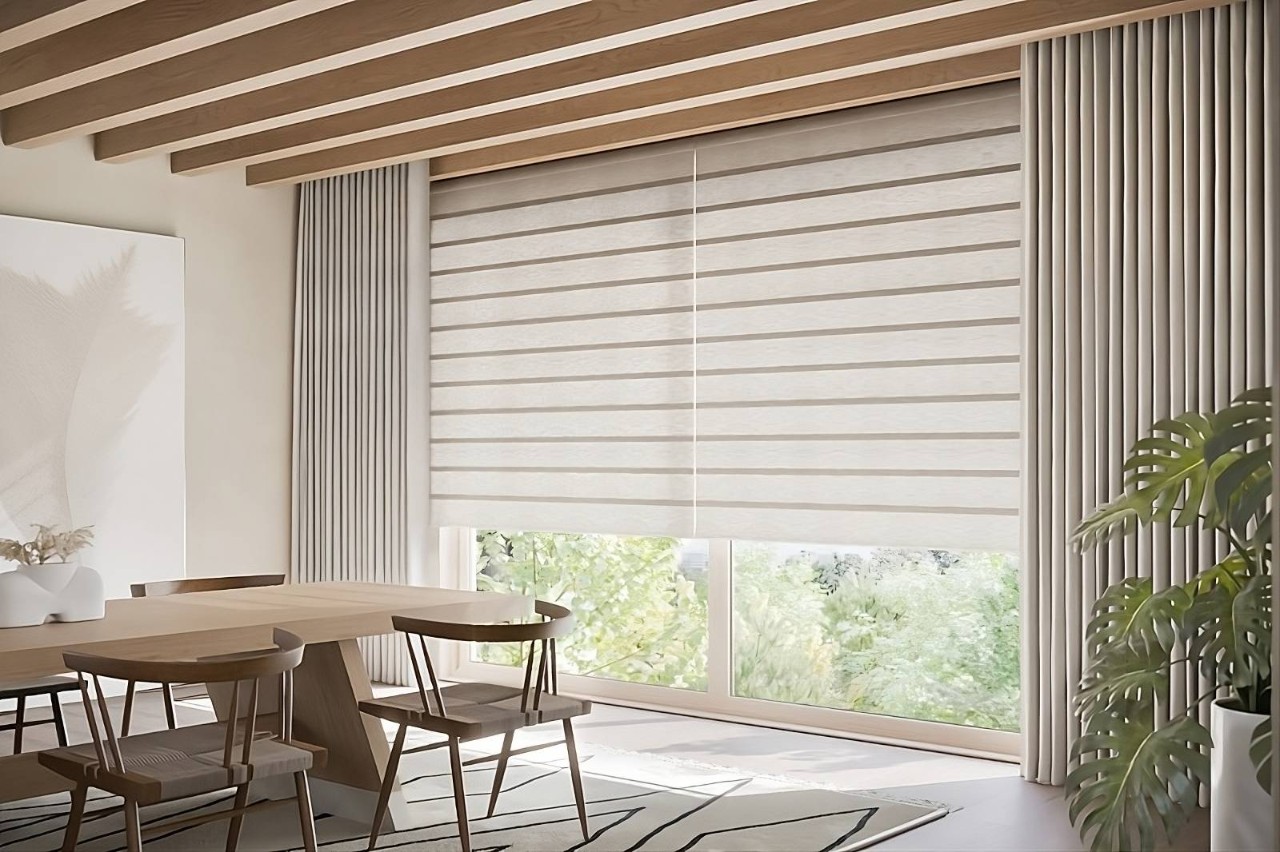 Neutral Hunter Douglas motorized Roman shades on a large window pane in a chic dining room at North Idaho Blinds, Shades & Shutters near Hayden, ID