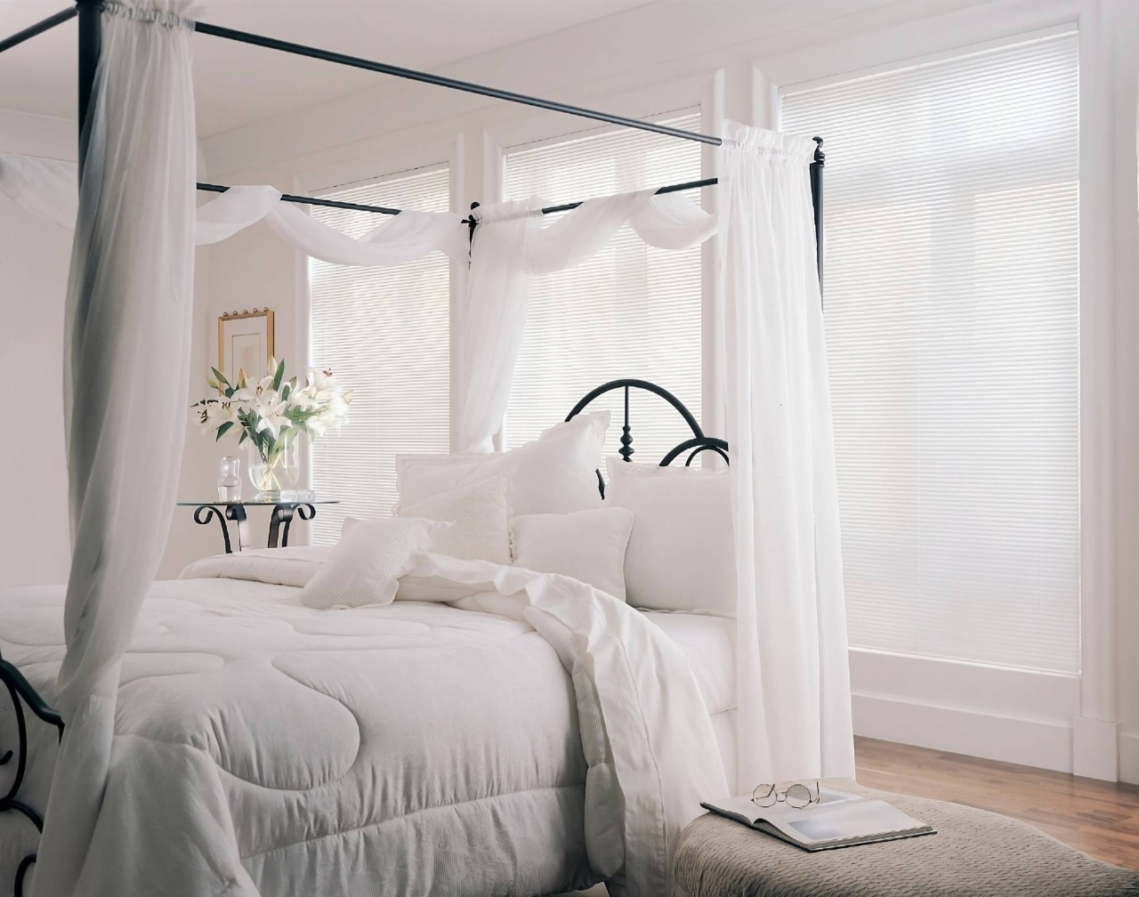  Hunter Douglas Modern Precious Metals® Mini Blinds on tall windows in a mostly white bedroom at North Idaho Blinds, Shades & Shutters near Hayden, ID