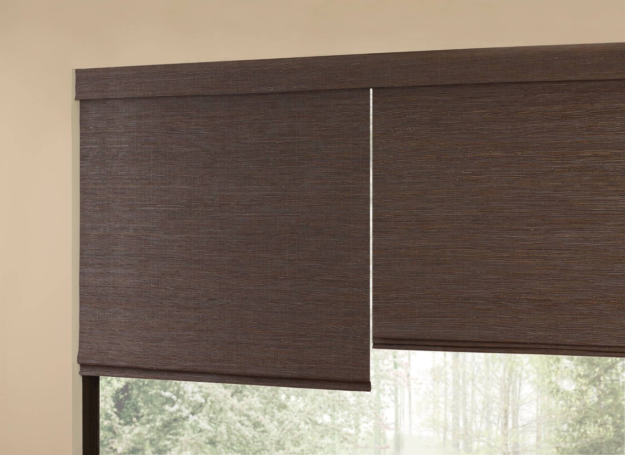 Hunter Douglas Provenance® Woven Wood Shades halfway closed on a window near near Hayden, ID