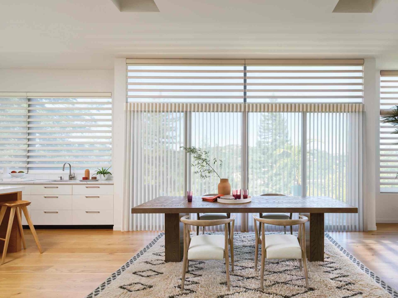 Hunter Douglas Luminette® Sheer Panels on windows and sliding doors in a large, chic eat-in kitchen at North Idaho Blinds, Shades & Shutters near Hayden, ID