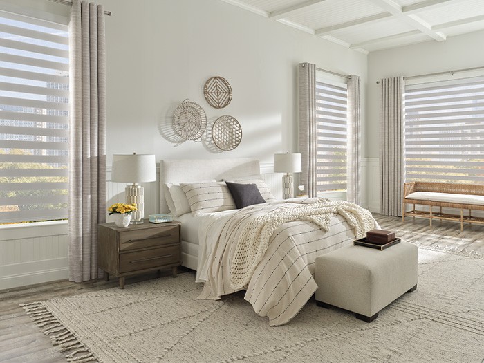 Bedroom with windows featuring Designer Banded Shades with PowerView® Automation.